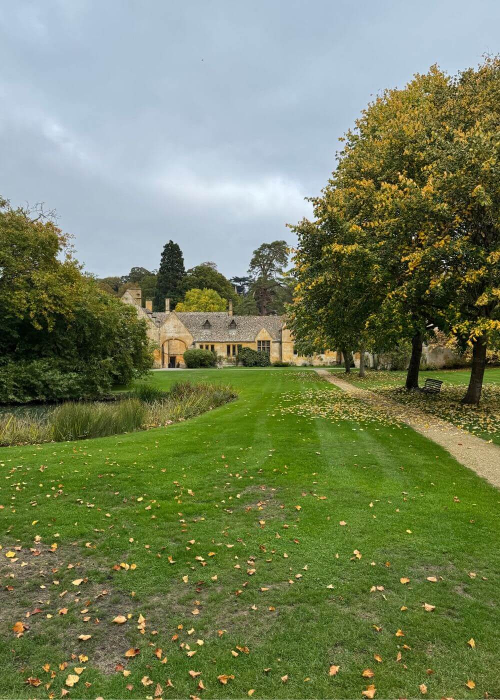 Long garden vista toward the manor through mature trees