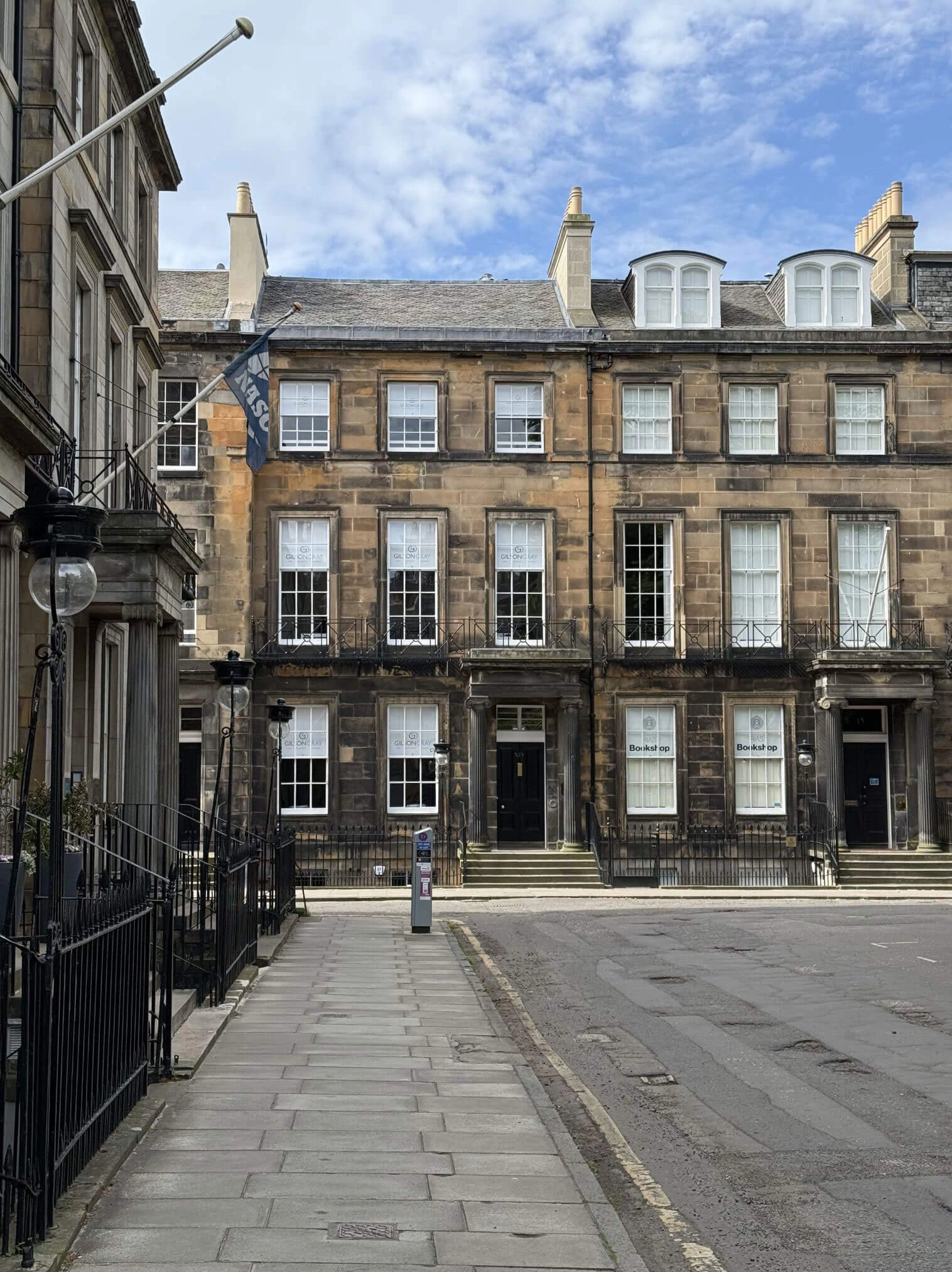 Stone buildings surrounding a paved street corner