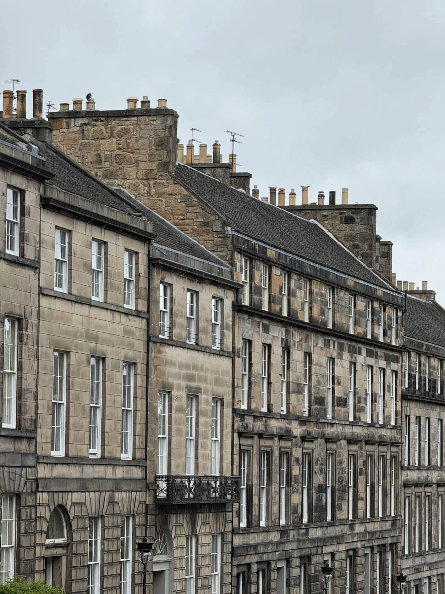 Long stone terrace with repeated windows and chimneys