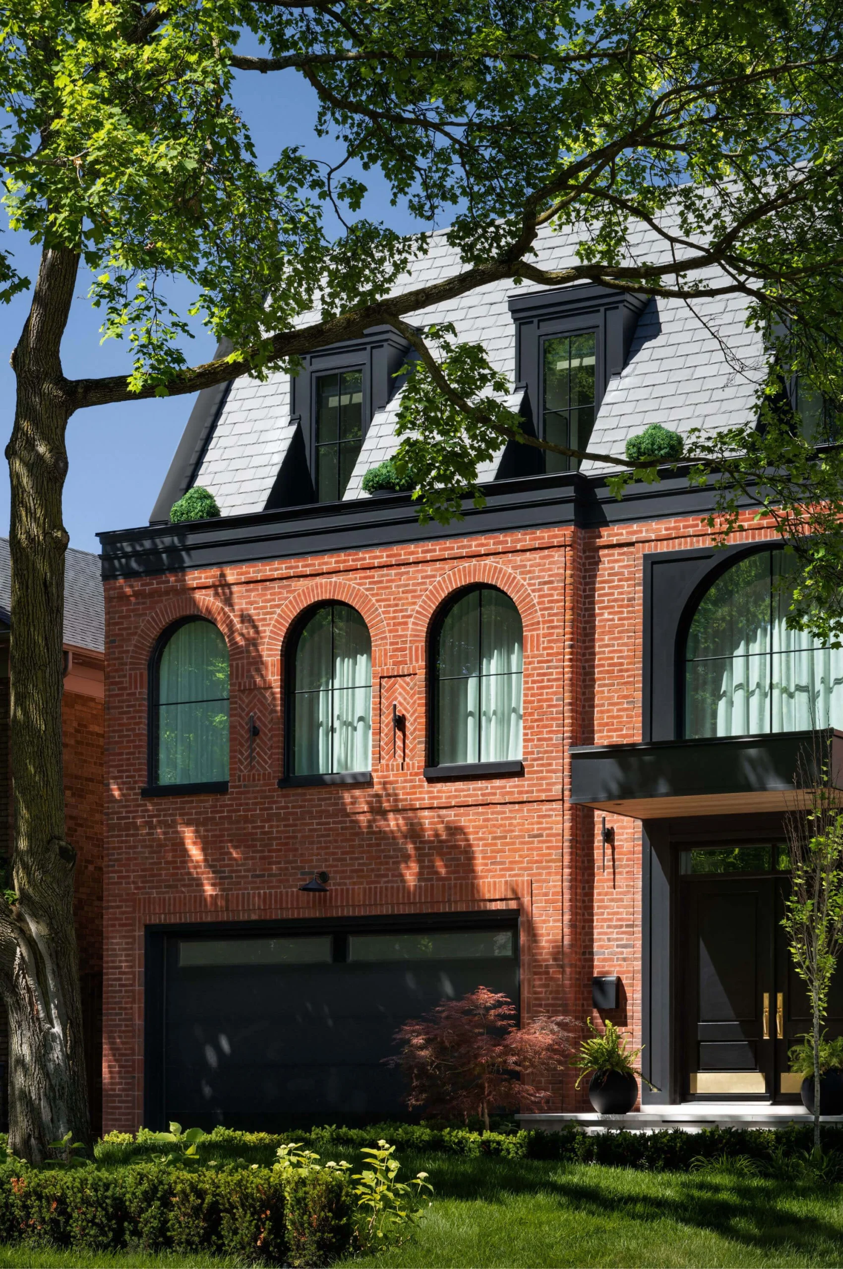 Detailed masonry and arched windows of the Bloor West Brownstone