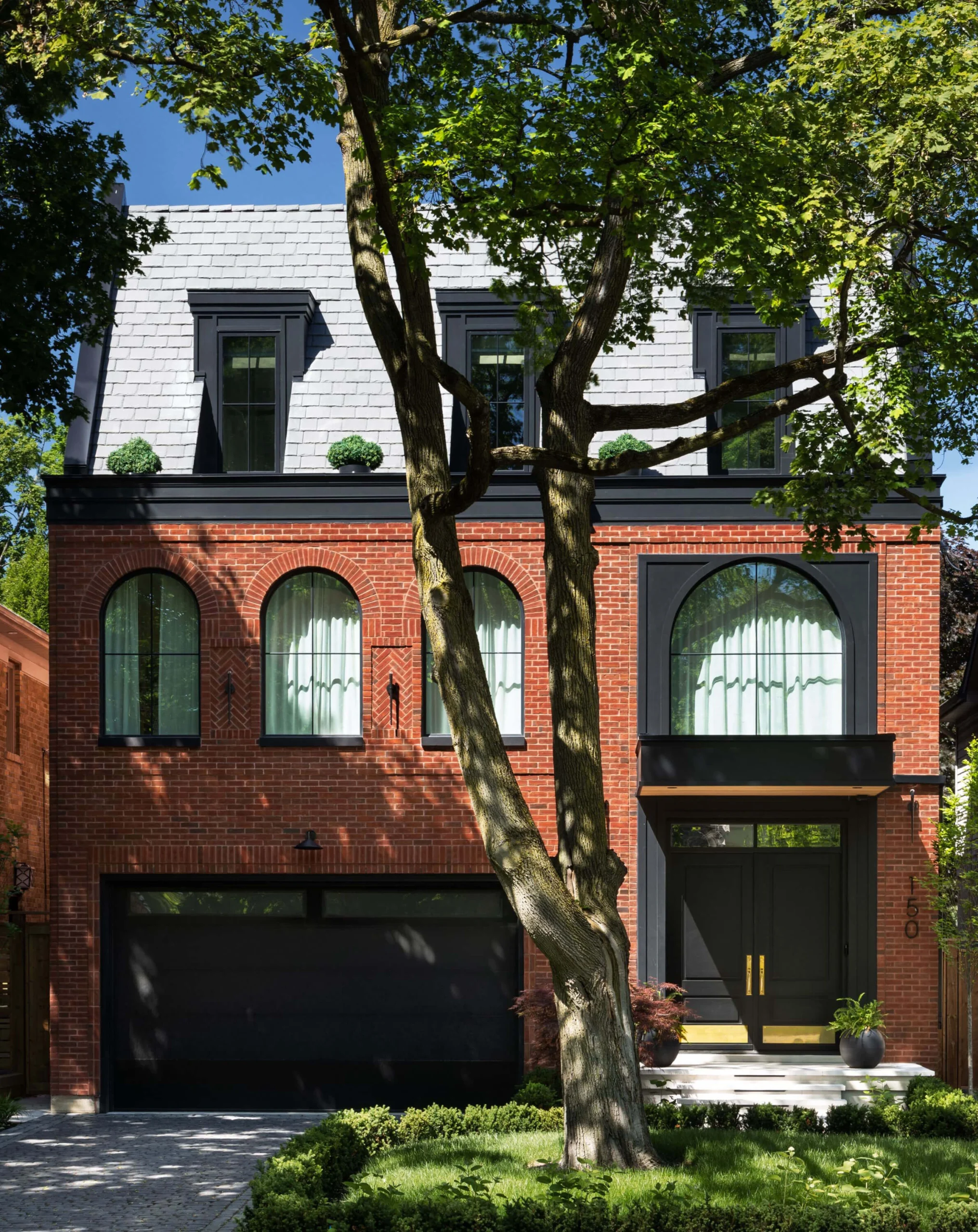 Stepped roof massing and rooftop terrace of the brownstone