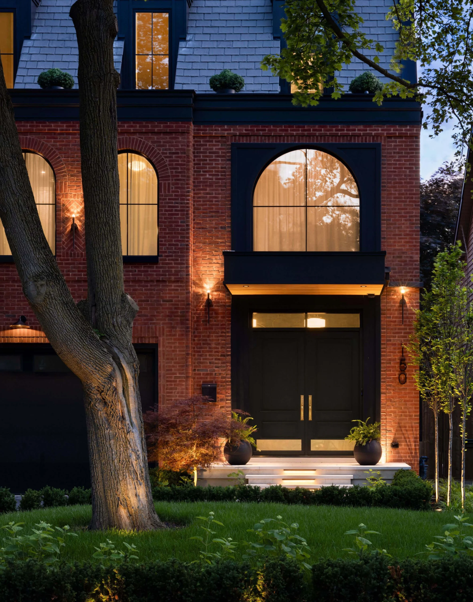 Herringbone brickwork and arched windows on the brownstone facade