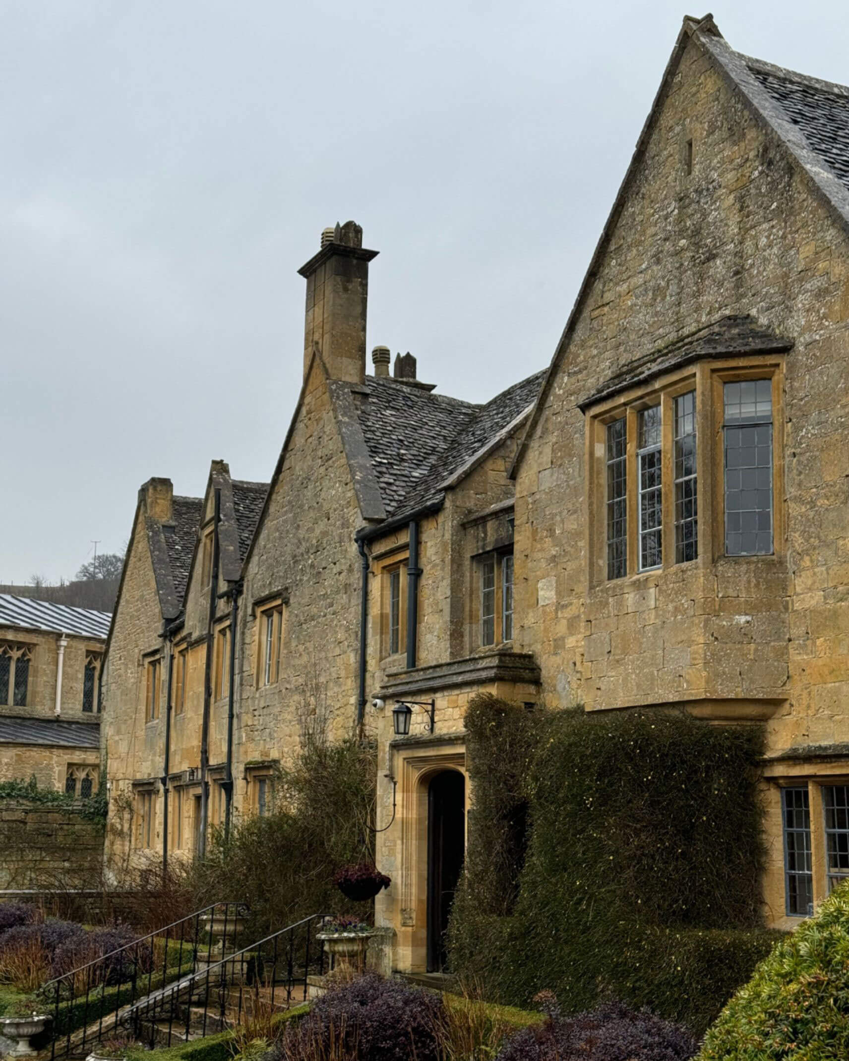 Gabled limestone facade of Buckland Manor