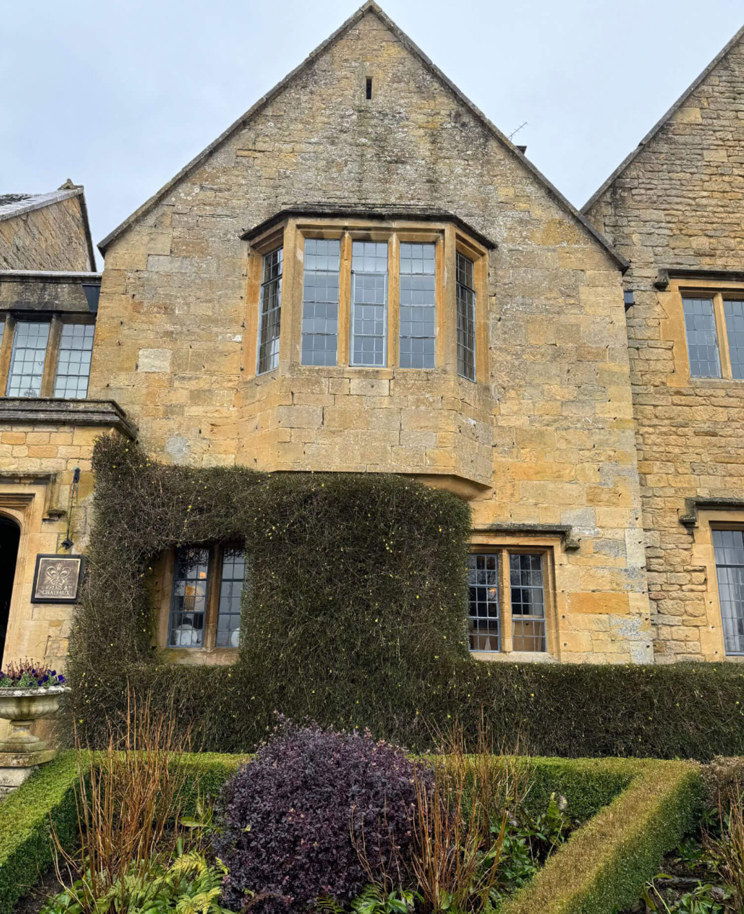 Projecting stone bay beneath a steep manor gable