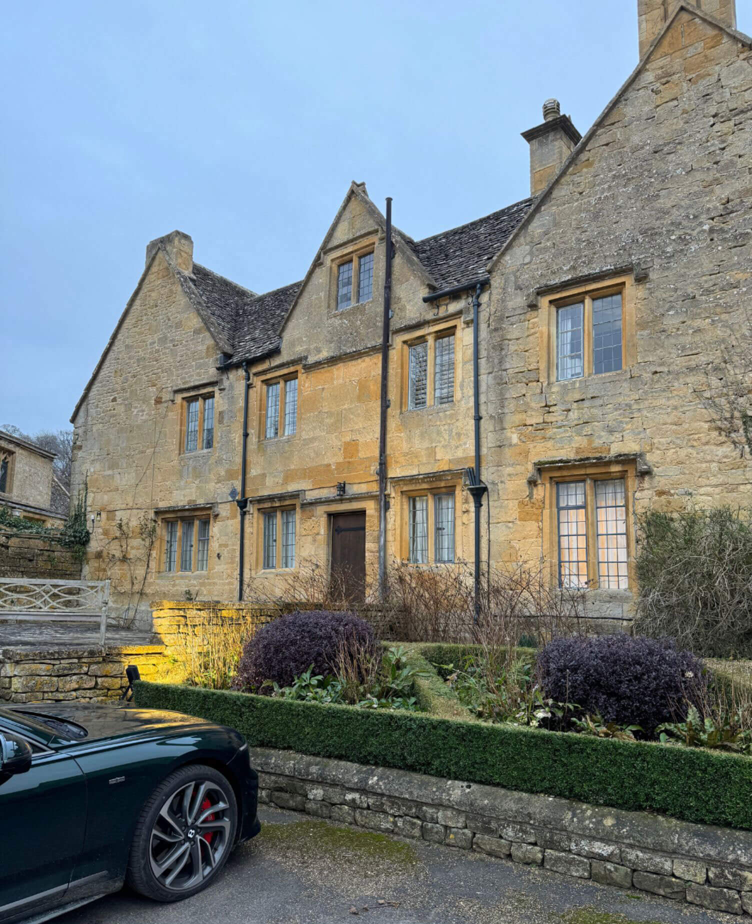 Long gabled manor facade beside the motor court