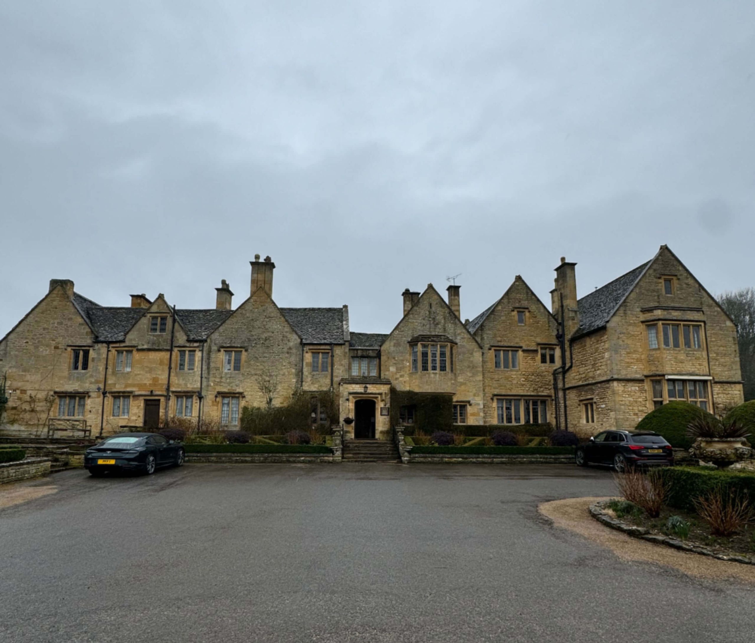 Panoramic view of Buckland Manor across its motor court