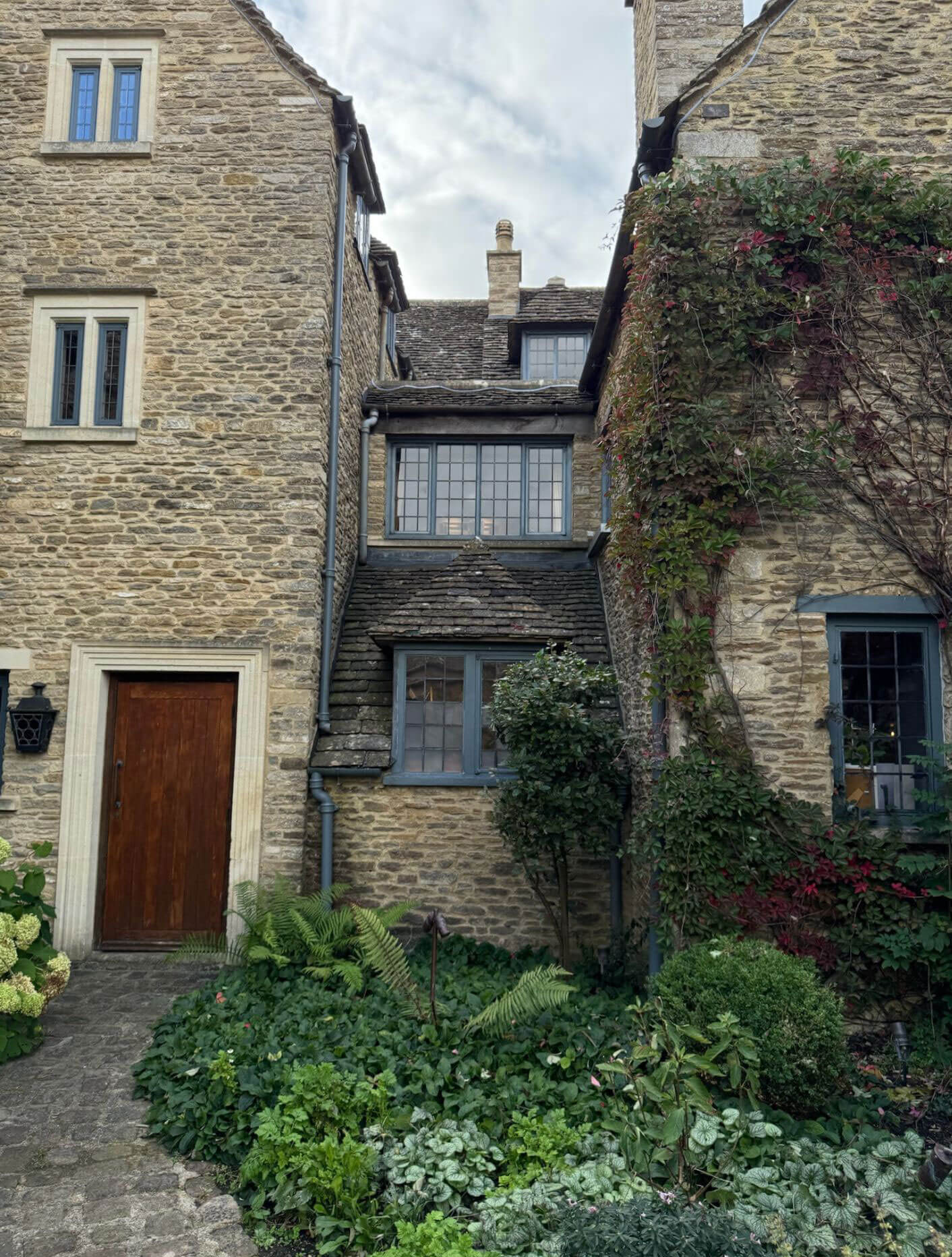 Stone courtyard walls and connecting glazed passage