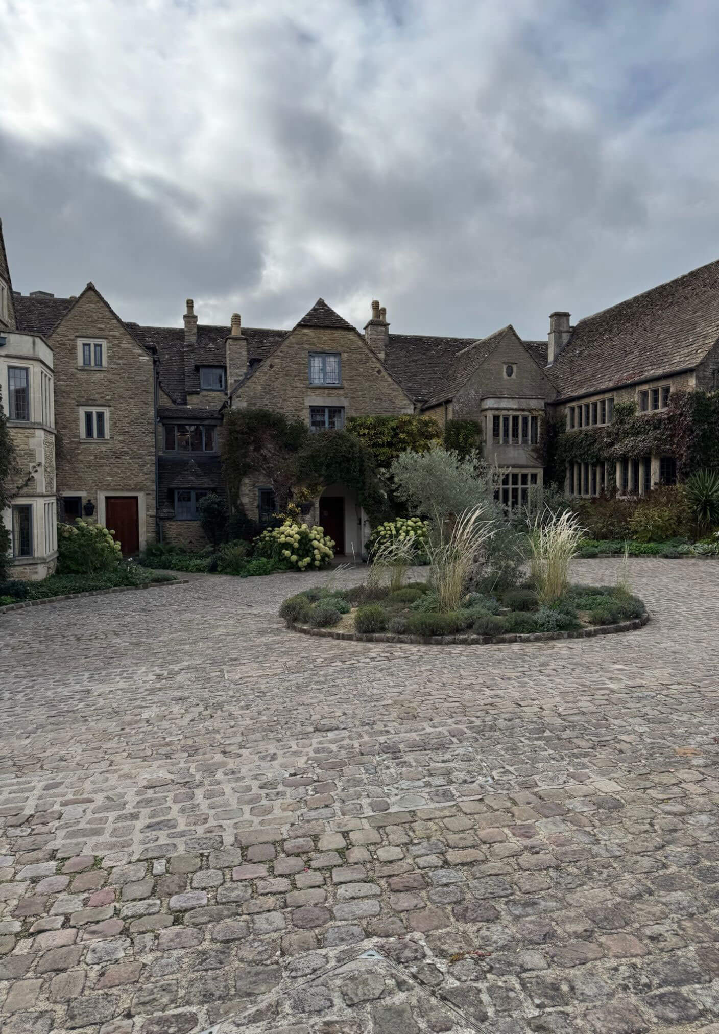 Cobbled forecourt enclosed by manor wings