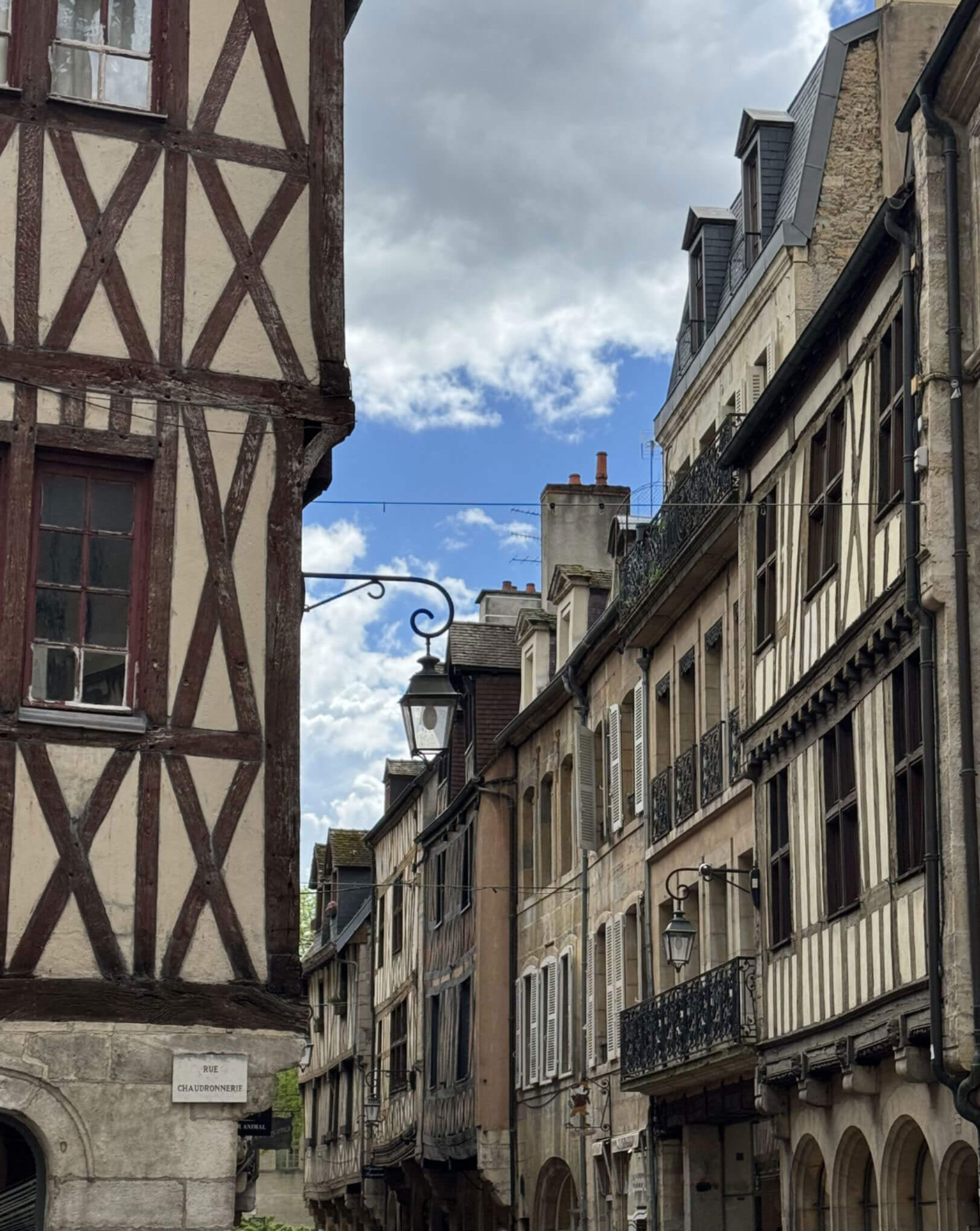 Half-timbered facades lining a narrow Troyes street