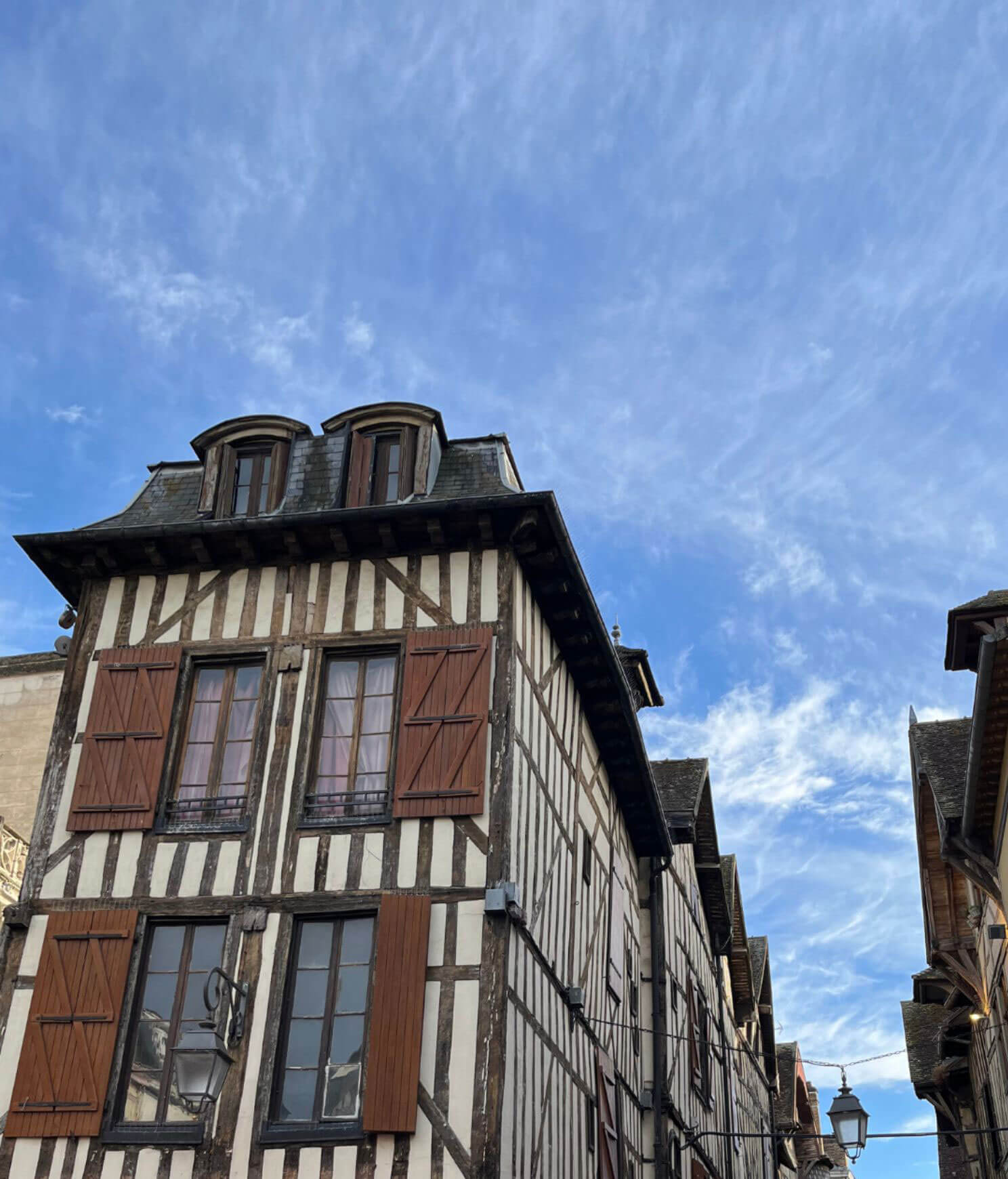 Corner timber-framed building with an ornate roofline