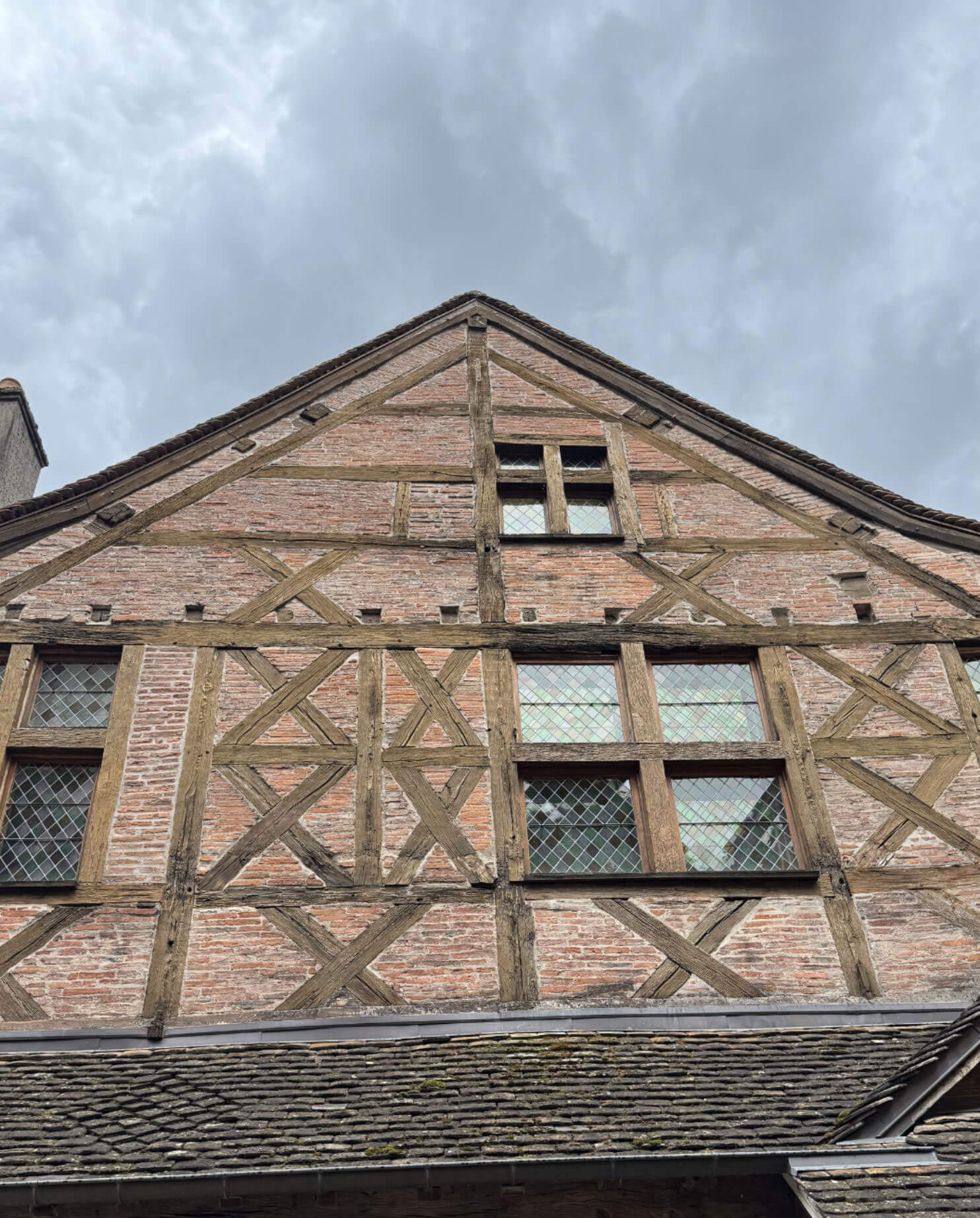 Brick infill between exposed timbers beneath a gable