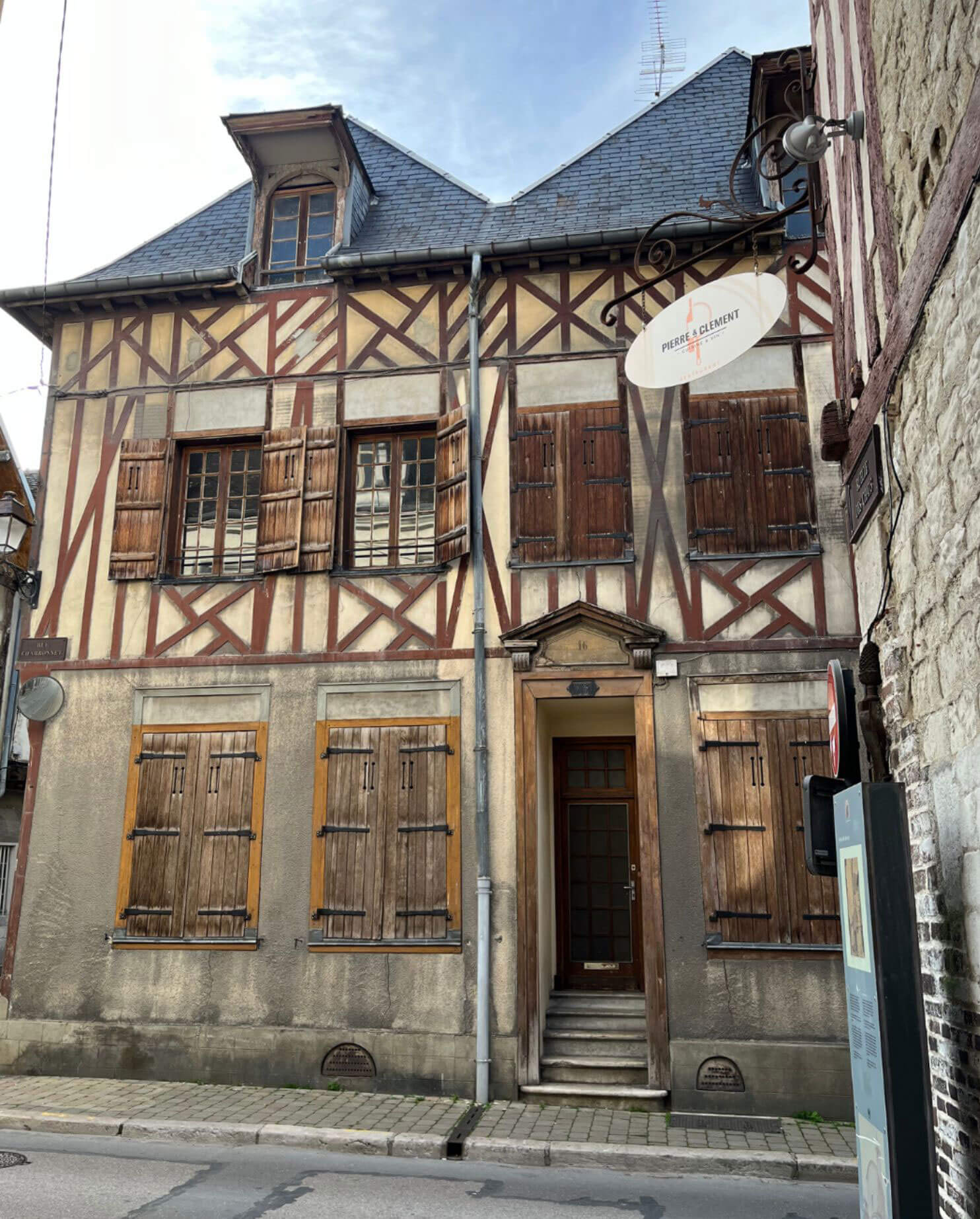 Ornate half-timbered house with a central stone doorway