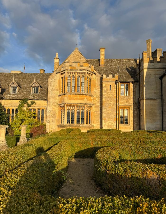 Historic stone buildings and formal gardens at Ellenborough Park Hotel