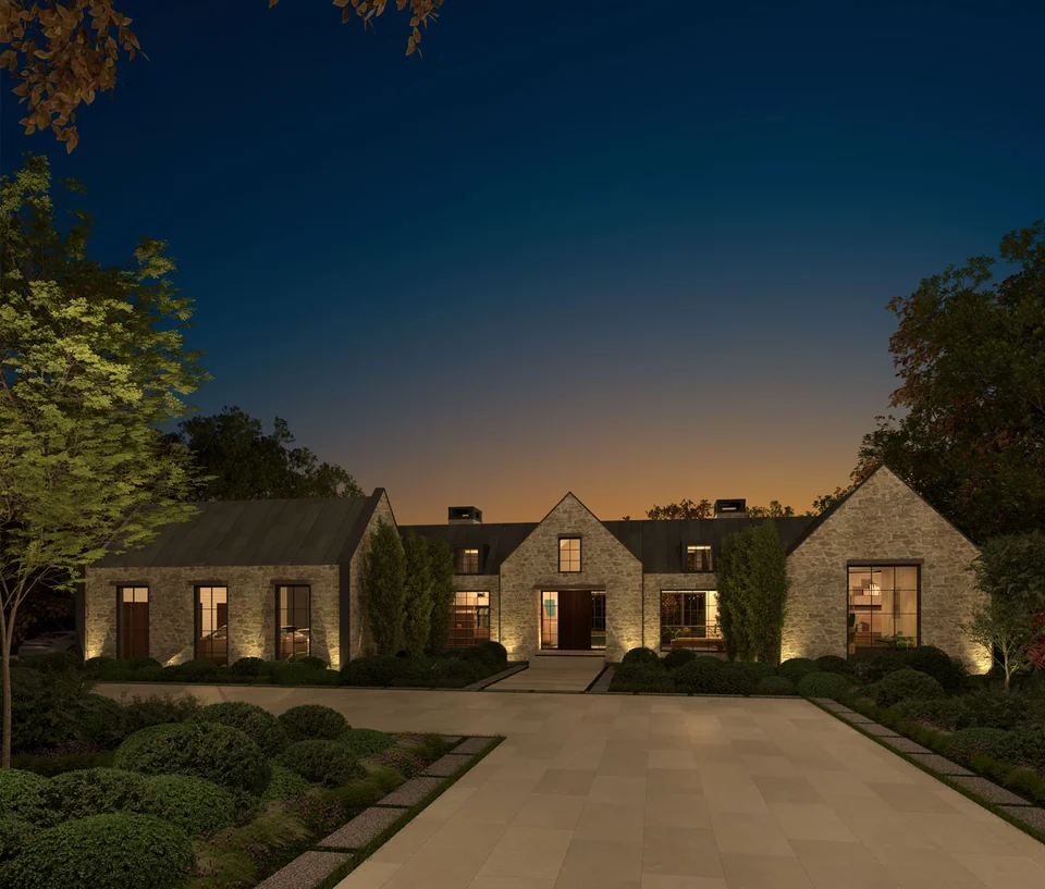 Stone homes lining a landscaped entrance courtyard at dusk